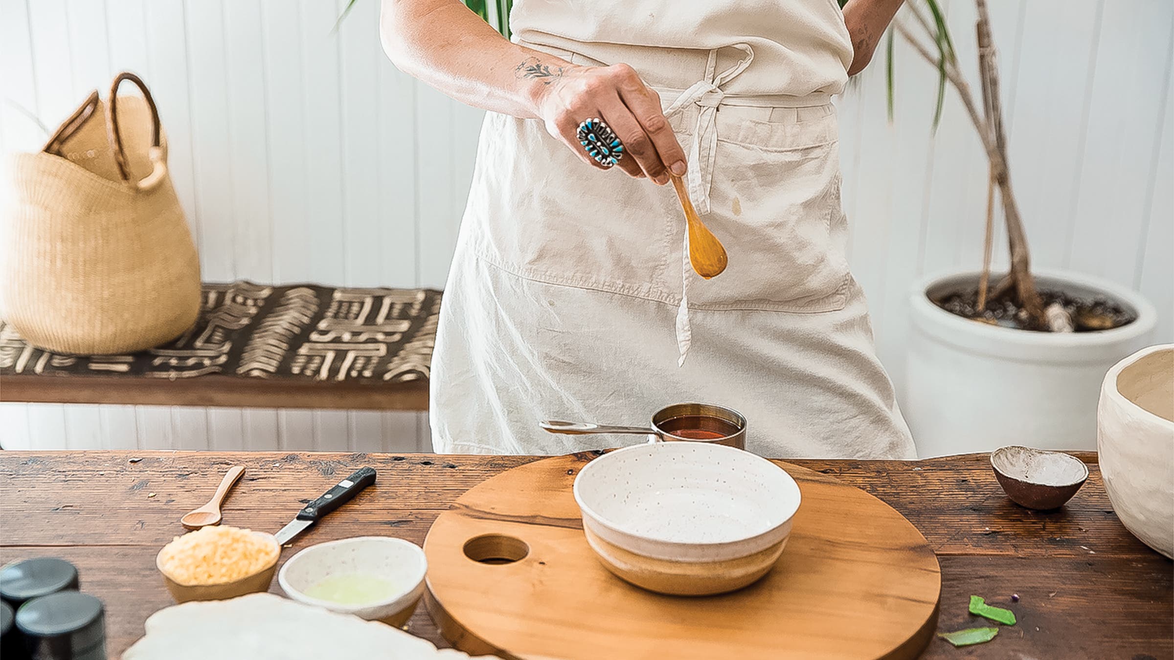 Woman making a homemade salve at Poppy and Someday