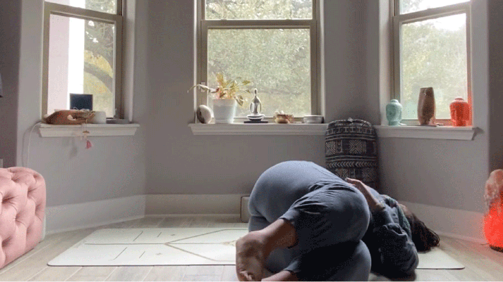 Premium Photo  A woman practicing yoga in a room with a window behind her.