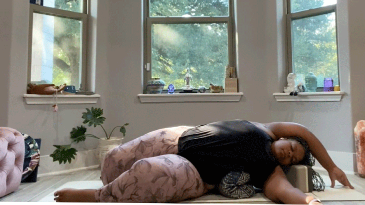 Woman lying on her side stretching in yin yoga