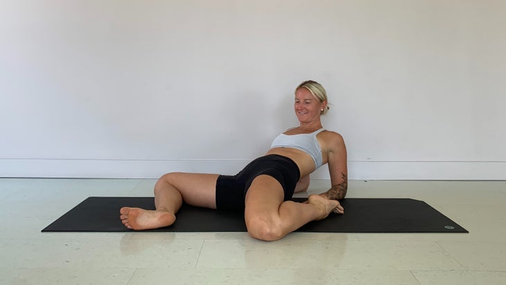 Woman doing a quad stretch for low back pain relief