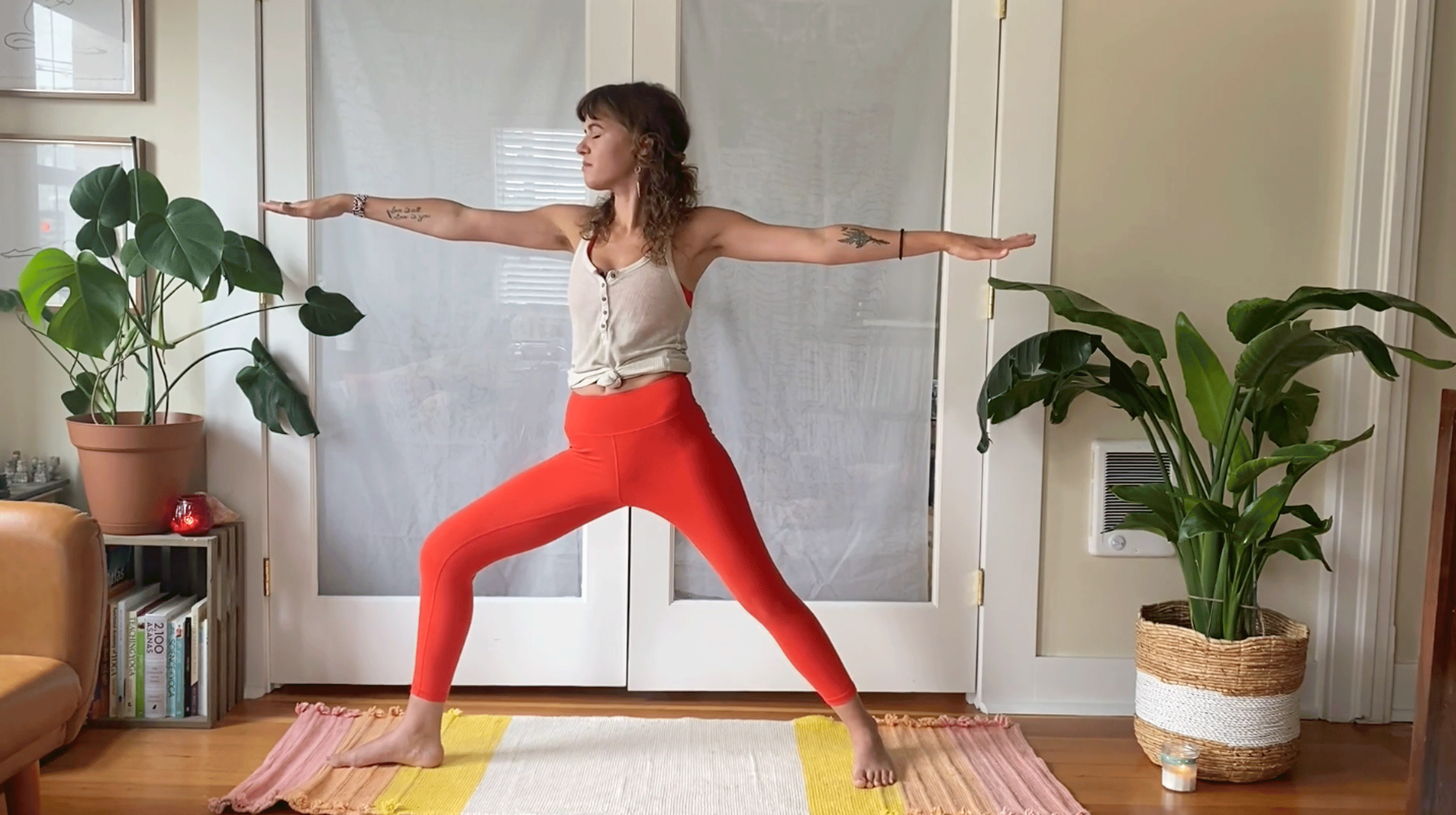 Woman standing on a yoga mat in Warrior 2