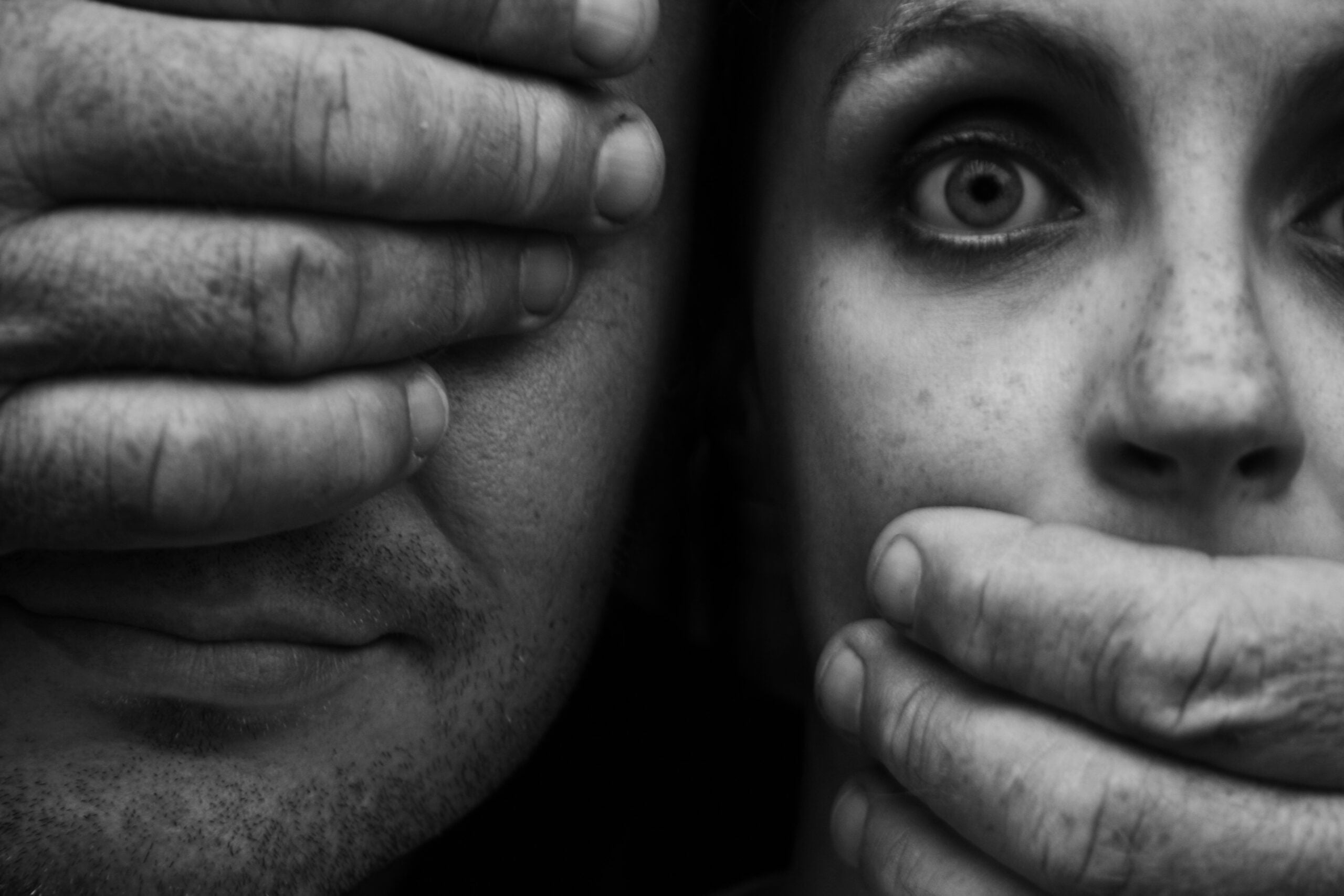 Man with hand covering his eyes and woman with hand covering her mouth as portrayed in cult documentaries
