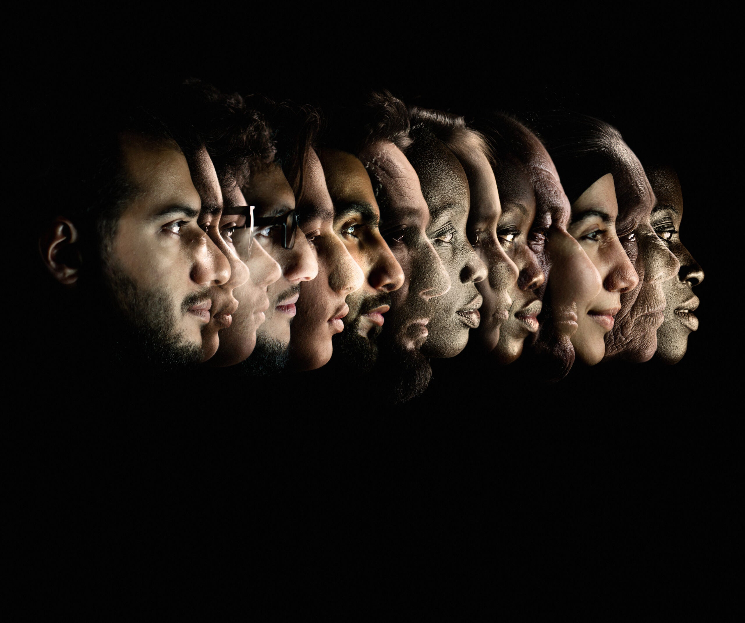 Profiles of a people of different races and ethnicities on a black background