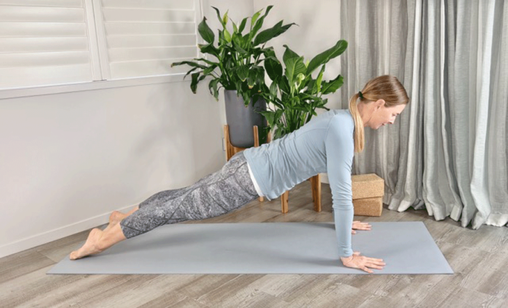 Woman practicing yoga with her toes pointed