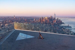 Woman doing Downward Dog on The Edge Observation Deck in NYC