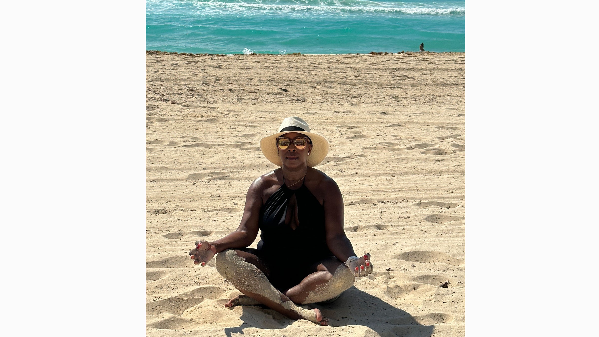 Julia Coney practices yoga on the beach