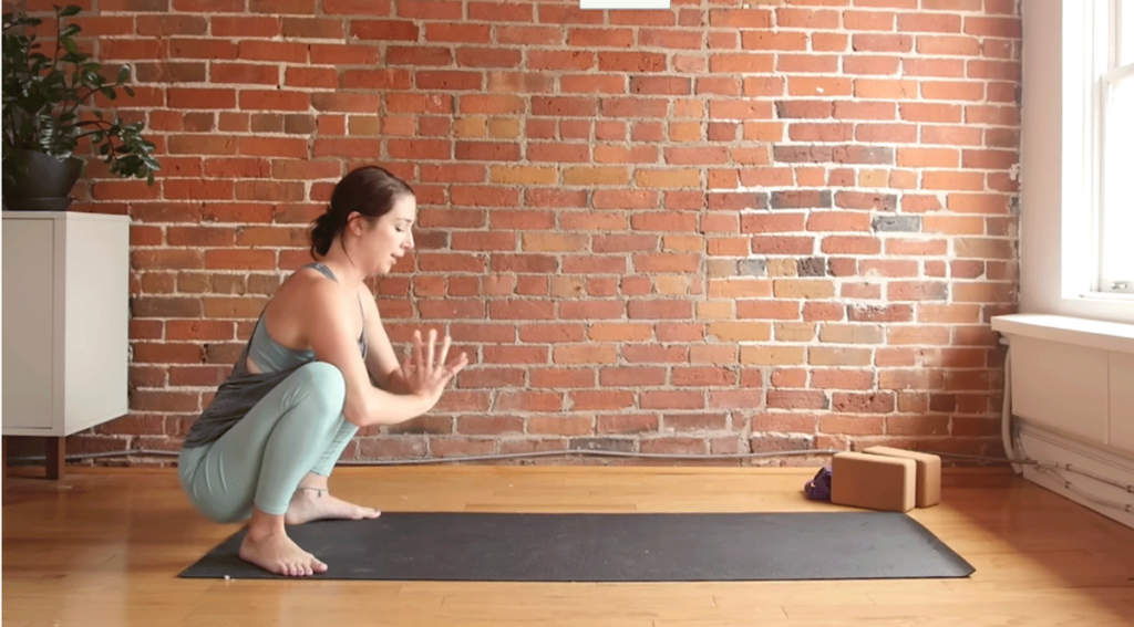 Kassandra Reinhardt teaching a yoga squat as part of a full-body stretching routine