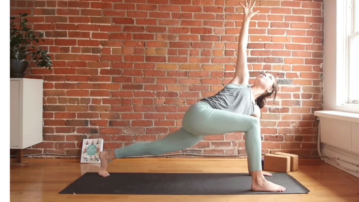 Kassandra Reinhardt teaching yoga in a twisting lunge as part of a full-body stretching routine