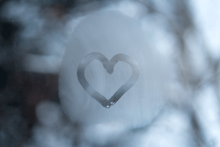 Fog on the window with a painted heart