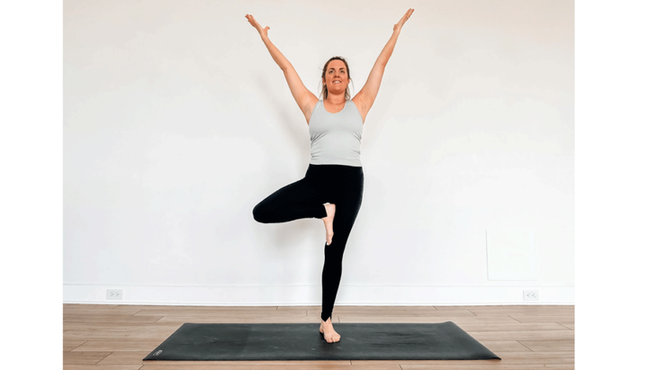 Yoga teacher practicing core strength in Tree Pose