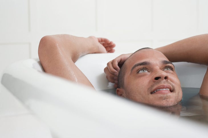 A man takes a bath with Epsom salt 