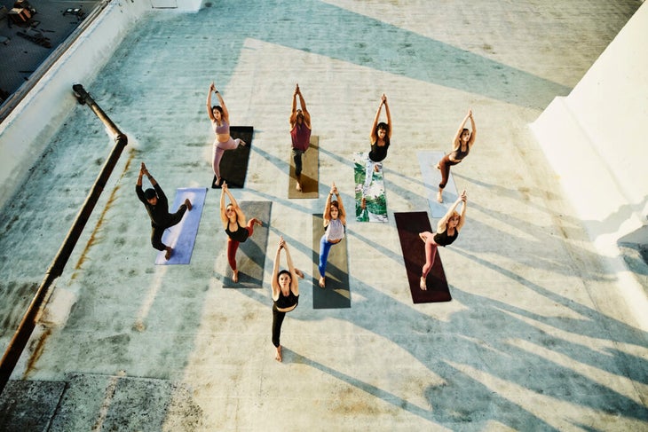 People practice rooftop yoga