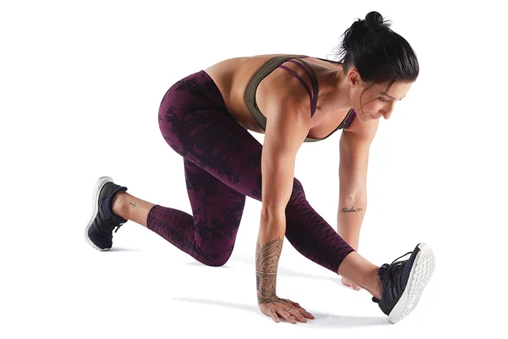 Woman athlete practicing half split, which is one of the best hip stretches for athletes