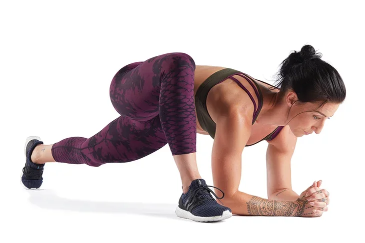 Woman athlete practicing a lizard lunge, which is one of the best hip stretches for athletes