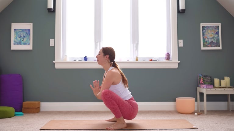 If your heels lift off the mat during a squat, tuck a rolled blanket beneath your heels for support. (Photo: Yoga With Kassandra)