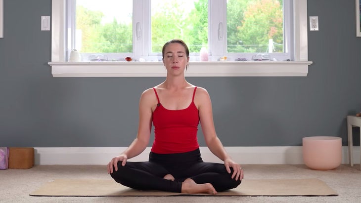 Woman sitting cross-legged in meditation