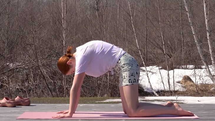 yoga instructor in cat-cow pose