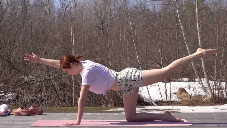 yoga instructor in bird dog pose