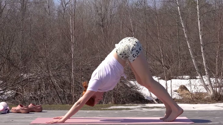 yoga instructor in downward-facing dog pose