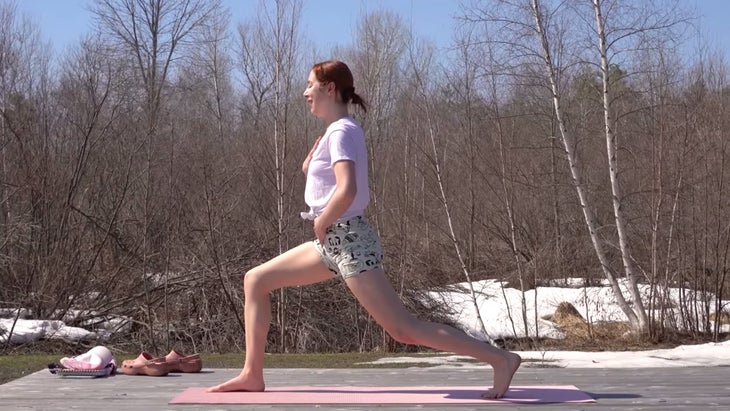 yoga instructor in high lunge pose