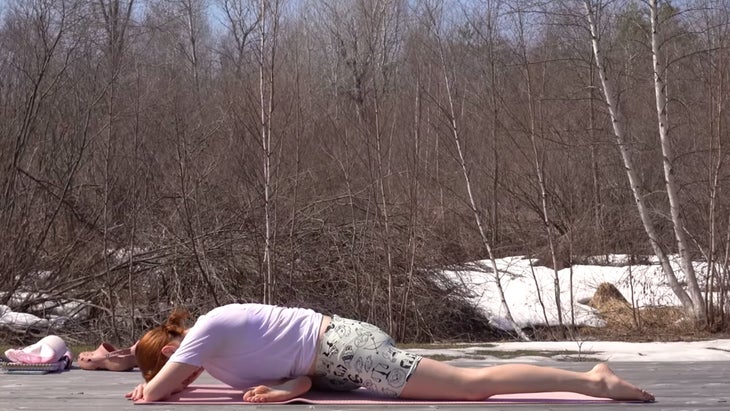 yoga instructor in pigeon pose