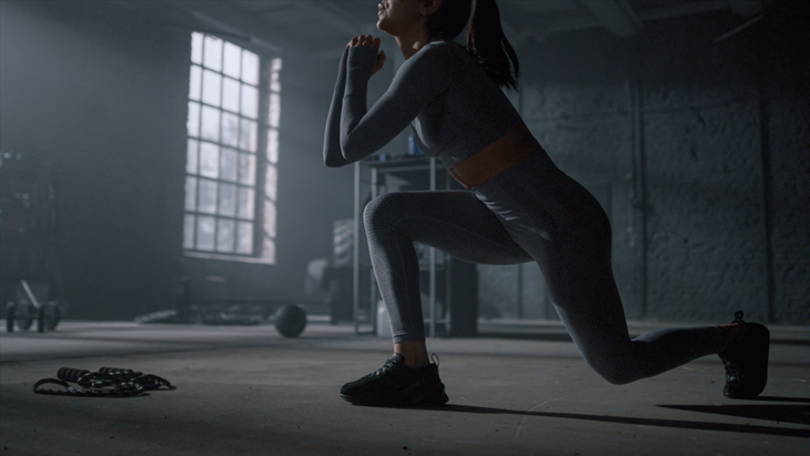 Woman practicing lunges during a 10 minute workout at home