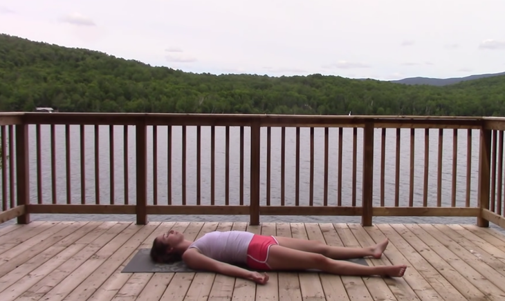 Yoga With Kassandra practicing Savasana at the beginning of a 20-minute yoga practice