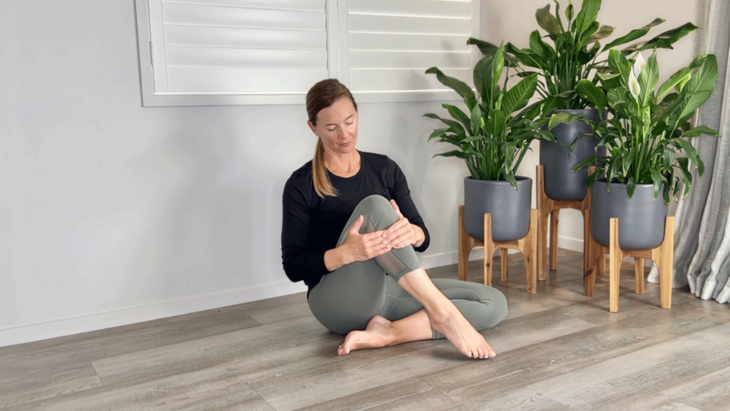 Seated tibialis anterior stretch with someone doing an apres-ski stretch by pressing on the anterior tibialis.