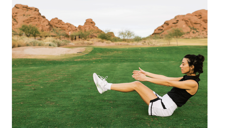 Woman practicing Boat Pose or a V Sit on a golf course.