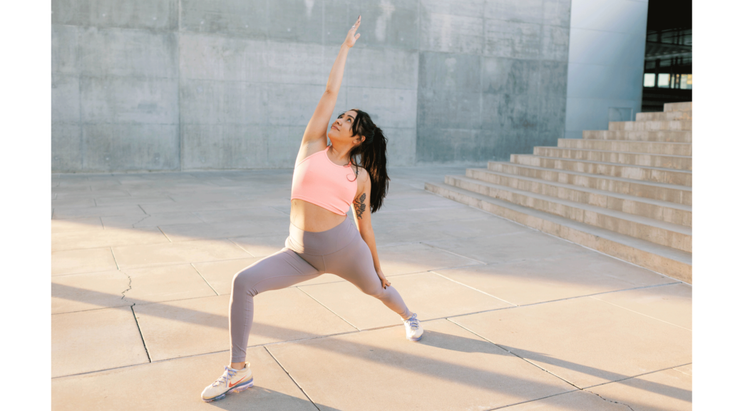 Woman on a sidewalk in central Phoenix practicing strength exercises for runners