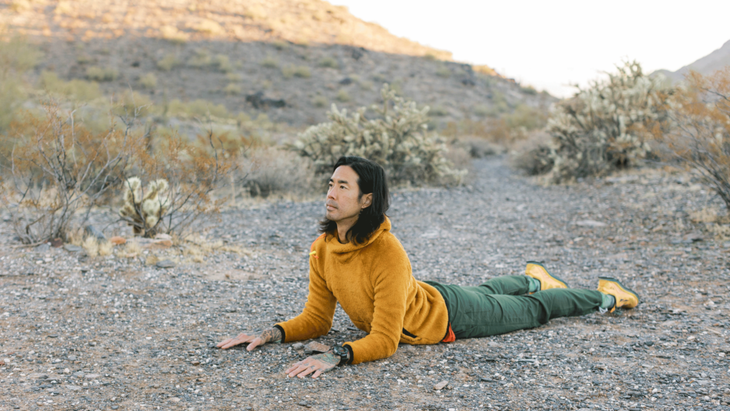 Backpacker practicing a simple backbend known as Sphinx at Piestewa Peak in the Sonoran Desert