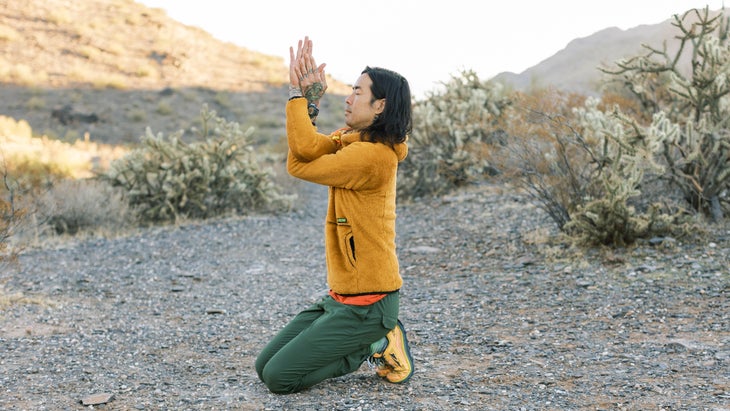 hiker performing yoga poses near their tent in the Arizona desert