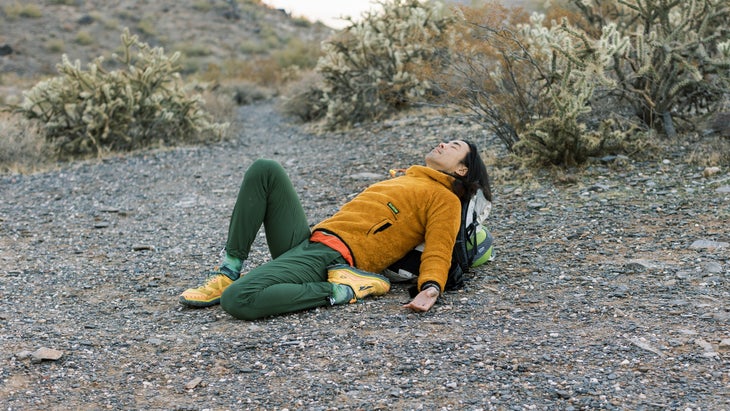 Backpacker in a yoga pose in the vast Arizona desert