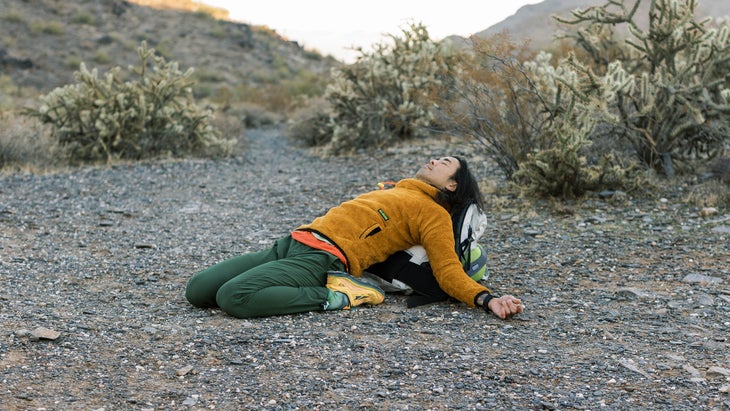 hiker using their backpack to do yoga poses in the Arizona desert