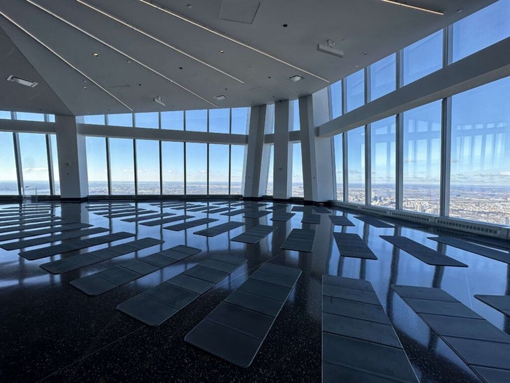 An image of One World Observatory with a yoga mat spread out on the floor before class.