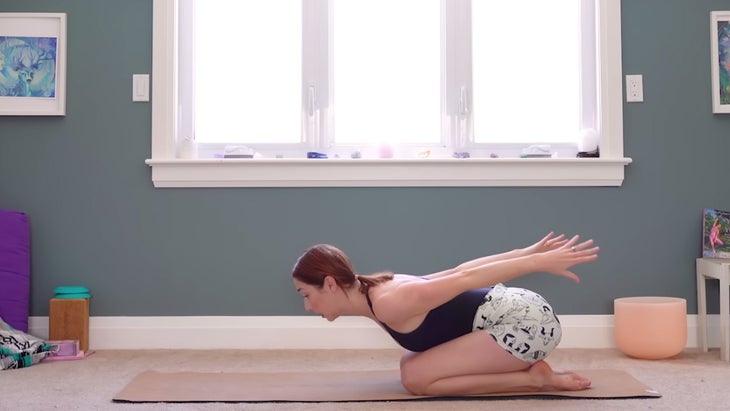 yoga instructor demonstrating dynamic camel pose squatting