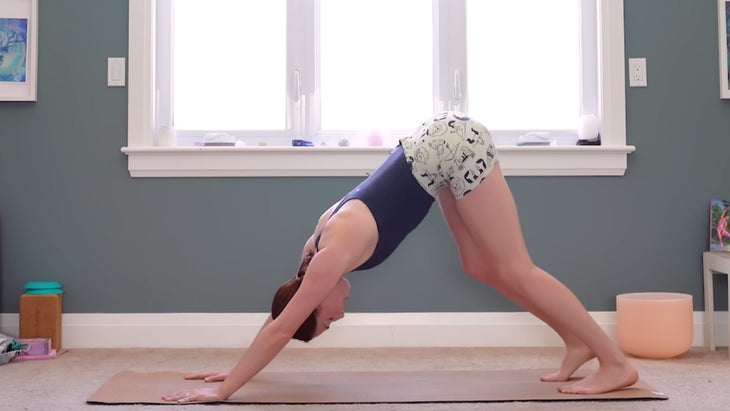 yoga instructor demonstrating downward facing dog