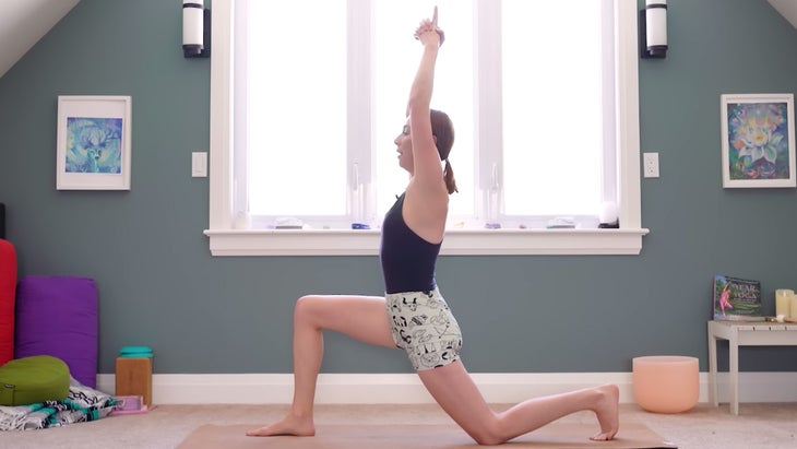 Woman on a yoga mat demonstrating a low lunge