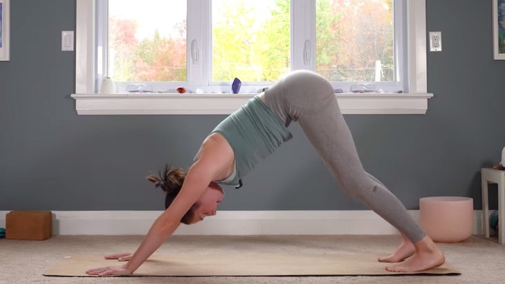 Woman in Downward-Facing Dog practicing yoga for Capricorn