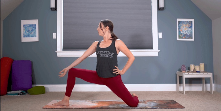 Woman kneeling on a mat in a version of Low Lunge