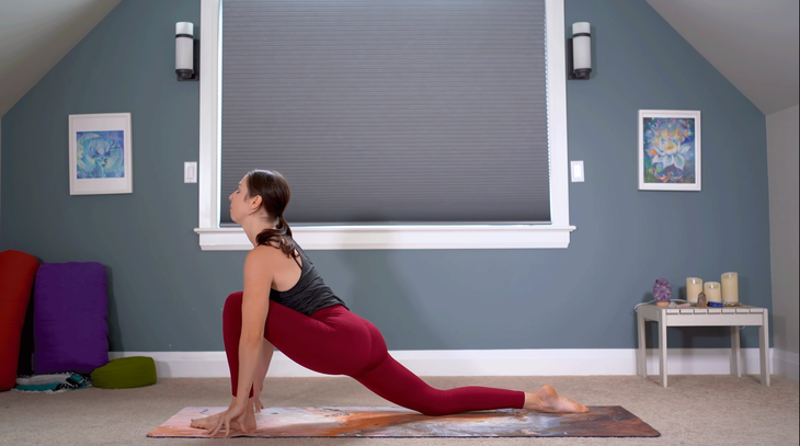 Yoga With Kassandra practicing a Low Lunge on a mat