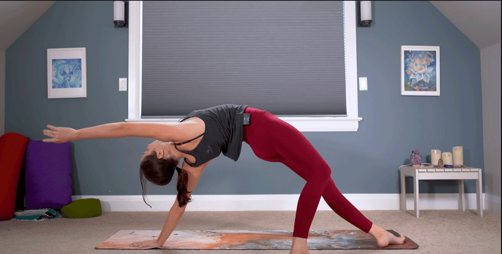 Woman practicing Wild Thing on a yoga mat.