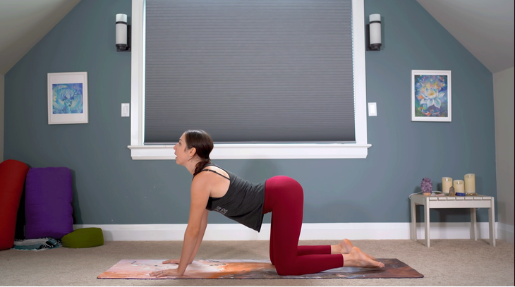 Yoga With Kassandra practicing Cow Pose on a yoga mat