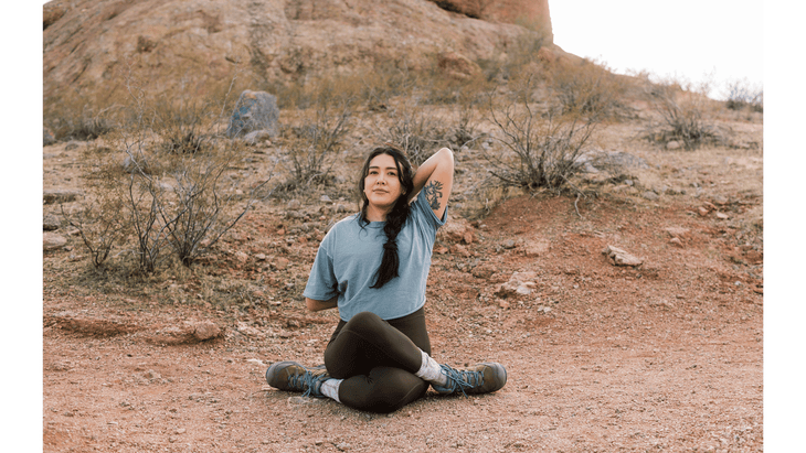 Woman practicing hiking stretches by using the yoga pose cow-face pose