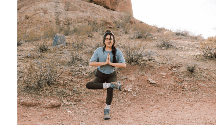 Woman practicing standing figure 4 stretch