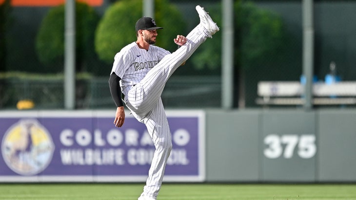 Kris Bryant of the Colorado Rockies stretching on the baseball field