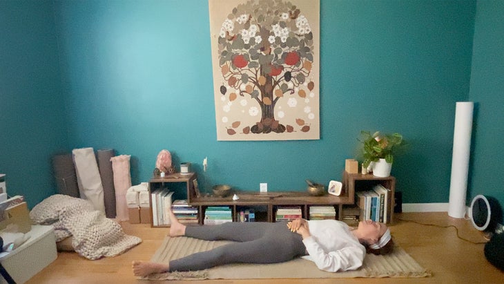 woman practicing yoga poses on a mat