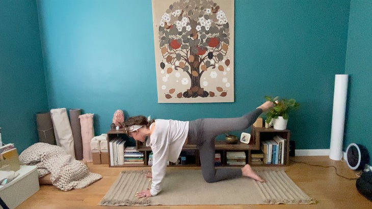 woman practicing yoga on a mat