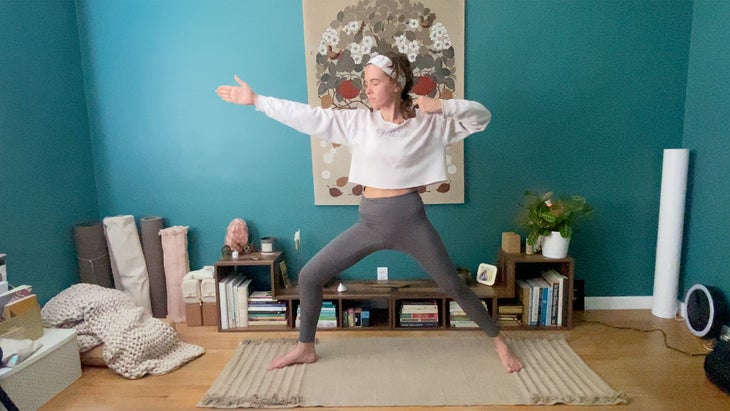 Woman practicing yoga standing on a mat