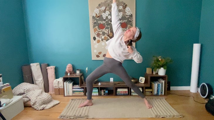 woman practicing a yoga post on a mat
